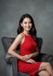 © CrazyJuke - Radiant Beauty: A captivating woman radiates elegance, her smile echoing the sophistication of the timeless setting. Her striking red dress accentuates her poise.