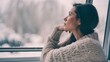 © VistaVisions - Winter depression, seasonal affective disorder mental health woman sad comtemplative looking out the window alone