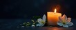 © jiratip - Dark background condolence card design; burning candle, white flowers, copy space, card, mourning, template