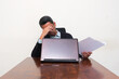 © KrishnaTedjo - A businessman falls asleep in front of his laptop