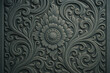 © Chiraphon - Floral Ornament: A detailed shot of intricate floral designs, embodying the grace and beauty of nature, meticulously carved onto a dark surface, forming an ornamental artwork.