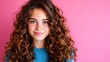 © JoxyAimages - A portrait of a young woman with lovely curly hair against a vibrant pink background radiating warmth and positivity through her cheerful smile and bright eyes.