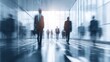 © ซัรริฮา เวาะแมะ - Modern business professionals walking through an illuminated airport or train station terminal with motion blur and futuristic ambiance
