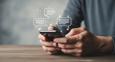 Person holding a smartphone with chat bubble icons floating above the device screen