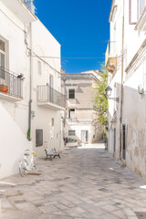 Naklejka na meble A shot of buildings among stone alleys and Mediterranean balconies in the historic center under a blue sky, Southern Italy. Grottaglie is a ceramics city.