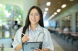 © maeching - Healthcare Female doctor with tablet for telemedicine, research or online consultation in hospital.