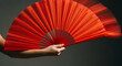 © Polina - Chinese dancer performing with a red fan, graceful movement on a dark background
