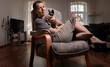 © Seva Zelikoff - Woman with sphynx cat looking at camera in modern living room