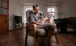 © Seva Zelikoff - Woman with sphynx cat looking down lovingly indoors