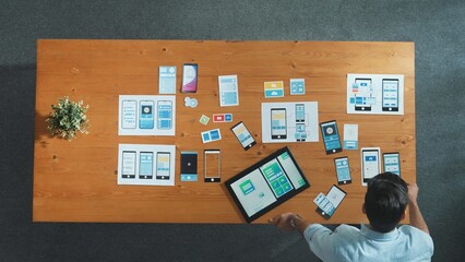 Top view of skilled developer walking and placing Ux Ui software. Smart business man put tablet on meeting table with mobile phone interface or icon. Investor plan develop software plan. Convocation.