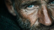 © Nawab stock - Intense closeup portrait of a weathered man with expressive blue eyes, captured in dramatic lighting