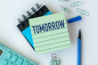© Pawel - A green notebook with the word Tomorrow written on it. A blue pen is sitting on top of the notebook