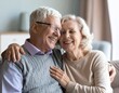 © Magdalena Wojaczek - Joyful senior couple sharing a loving embrace and warm laughter, celebrating enduring happiness together