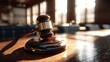 © Aini - Wooden gavel rests on a table in a sunlit courtroom