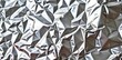 © tpadobestock - Shimmering silver foil background texture with subtle crinkles and highlights, ideal for elegant designs, illustration, crumpled