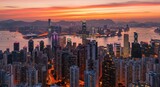 A panoramic view of Hong Kong's cityscape at sunrise, showcasing a vibrant array of illuminated skyscrapers and a tranquil harbor.