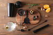© Pixel-Shot - Different bartender utensils and cocktail ingredients on wooden background