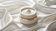 © Prosenjit - Cream Jar's Silk Embrace: A luxurious skincare cream jar rests on a cascade of lustrous, silky fabric, its elegant design suggesting the pampering of delicate skincare rituals.