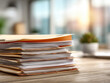 © Old Man Stocker - Stacked File Folders on Wooden Desk in Modern Office with Blurred Background