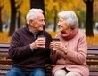 elderly woman and man drinking coffee on a park bench.