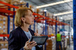 © Westend61 - Thoughtful manager standing with tablet PC in warehouse