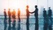 © hao - Business agreement concept showing blurred silhouette of business people shaking hands near large window in office building showing blurry cityscape. High quality