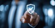 © shuai - Technology computer and internet cyber security and anti virus concept, Businessman pressing security shield with check mark icon with blurred office background. High quality