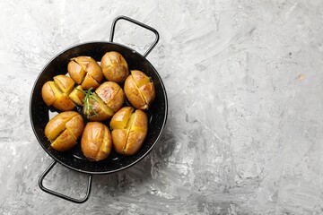 Wall Mural - Tasty baked potatoes with rosemary served on light grey table, top view. Space for text