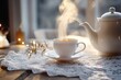 © dashtik - Warm tea being poured into white cup with lace tablecloth and bokeh background