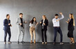 © Studio Romantic - Joyful enthusiastic business team dance against grey wall, celebrate successful deal, have fun together, satisfied after nice work, glad weekends are coming. Business success concept