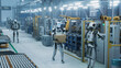© Gorodenkoff - Humanoid Robot Walking with a Box in a Smart Factory with Diverse Automated Robots, Transporters and Futuristic Equipment. Manufacturing Plant with Electric Vehicles on a Production Line. High Angle