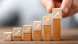 © Irina B - Kpi performance measurement with wooden blocks arranged by hand to represent business growth and success strategy