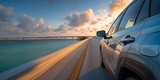 Modern car driving on scenic coastal highway at sunset with motion blur