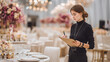 © Екатерина Чумаченко - Event planner overseeing table settings in a grand banquet hall, checking arrangements. Professional and focused, ensuring every detail is perfect.
