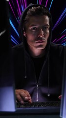 Wall Mural - animation of caucasian male hacker over pink and blue neon light trails