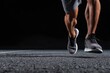 © Tarakan - Close-up of runner's legs and feet in motion on dark asphalt (1)
