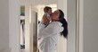 © Marco - Mother lifting baby close to her face in hallway, natural light, warm and loving family moment, candid authentic lifestyle scene, nurturing and bonding