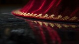 Red brocade vestment hem with gold fleur de lis reflected on polished black floor in elegant composition