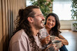© Migma_Agency - Happy couple laughing and drinking coffee at home