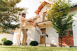 © Maria Vitkovska - Father swinging daughter in front of house, enjoying playtime together