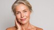 © Johannes - attractive gorgeous mature older woman looking at camera isolated on white background advertising skincare spa treatment mid age tightening face skin care rejuvenation cosmetics concept portrait no l