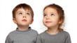 © Slavica - boy with inquisitive look gazing upward against ultrabright white background embodies sense of anticipation