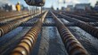 © melvilsky - Construction worker installing rebar on a construction site