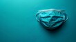 © Ummeya - Medical face mask protection against disease spreading on a teal background