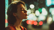 © iwaart - A woman with a thoughtful expression smoking a cigarette at night, with a bokeh-filled background of city lights.