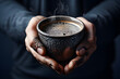 © photosaint - Holding a warm cup of coffee with a rustic feel in a cozy, dimly lit environment