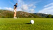 © Angler - Golfer about to hit a golf ball on a green