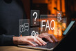 © Supatman - FAQ and AI chatbot support concept. Person typing on laptop, surrounded by question icons, automated answers, global access, intelligent solutions for customer service and digital assistance. Q and A