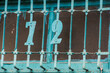 A blue iron window with the number 72 adorns an old house at Xian Guang Military Kindred Village Cultural Park in Taoyuan City, Taiwan, showing vintage style.