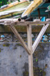 A handmade wooden clothes drying rack stands outdoors at Xian Guang Military Kindred Village Cultural Park in Taoyuan City, Taiwan, reflecting local craftsmanship.